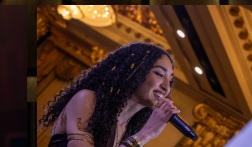 Performer on stage at The Grand Soirée